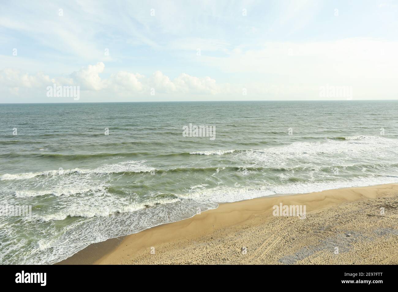 Beautiful sea with waves on sandy beach Stock Photo