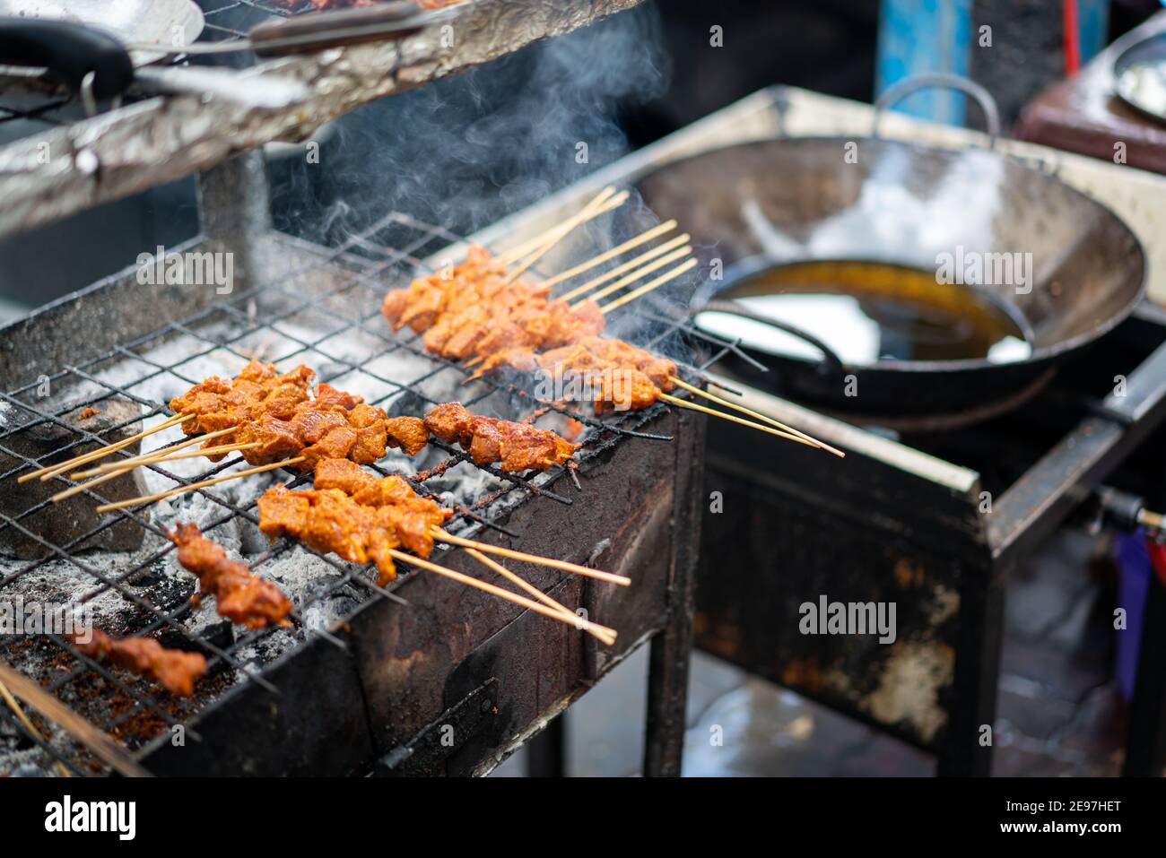 Black African woman cooking and selling street food Stock Photo