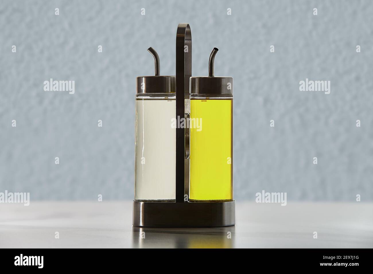 Two bottles with dispenser spout for cooking oil or vinegar in metal