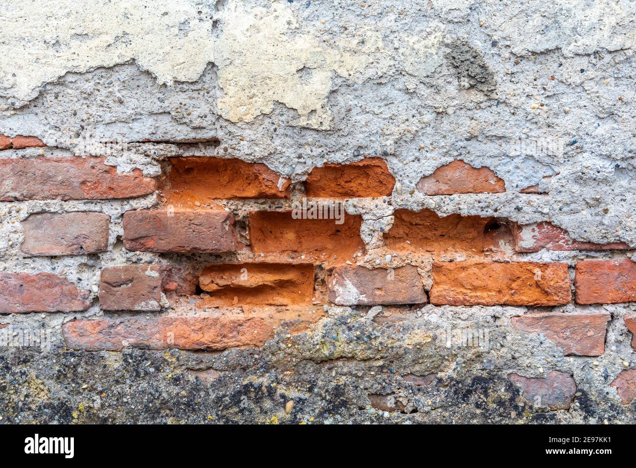 Old wall with crumbled plaster Stock Photo