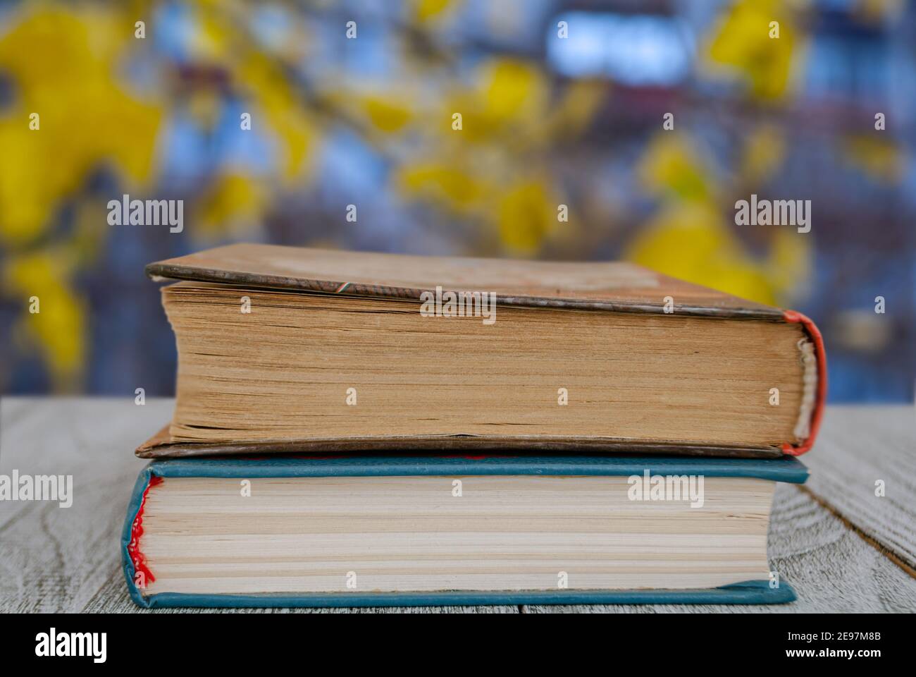 Two books on the table against the background of an autumn landscape for wallpaper Stock Photo