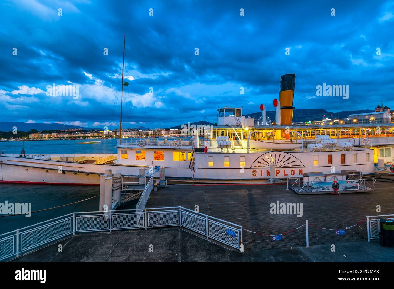 Geneva, Switzerland - Aug 14, 2020: the steam boat Simplon at the pier in Quai du Mont-Blanc ferry terminal at dusk, illuminated in the evening Stock Photo