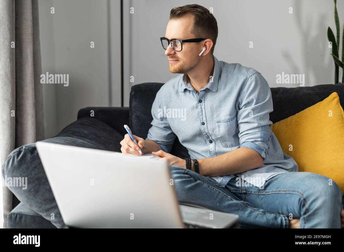 Intelligent businessman lost in thinks about solving a complex business problem, developing, engineering. Freelancer using laptop for working from Stock Photo