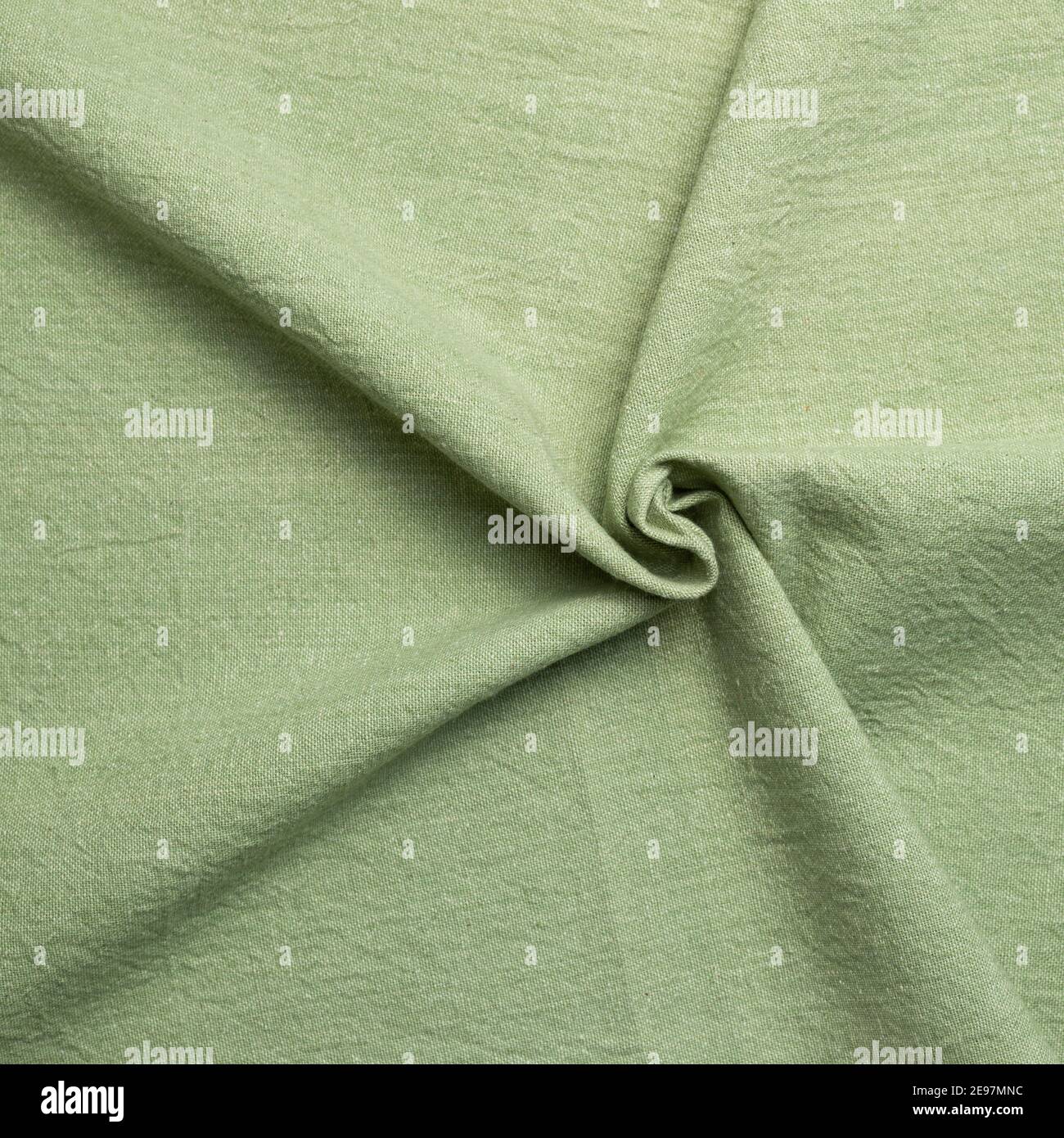 Crumpled natural green fabric texture background Stock Photo