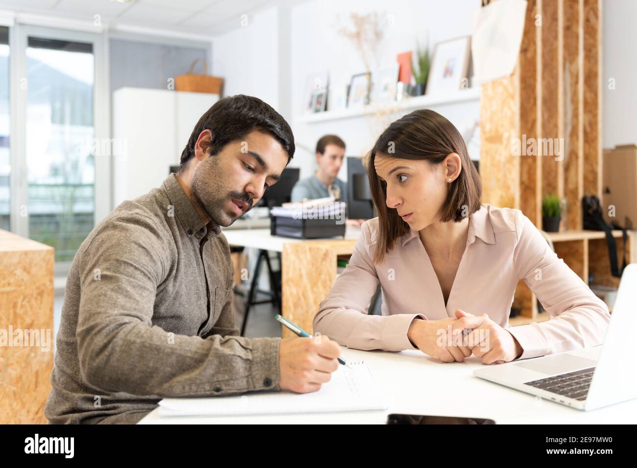 Coworkers chatting seriously in the office Stock Photo