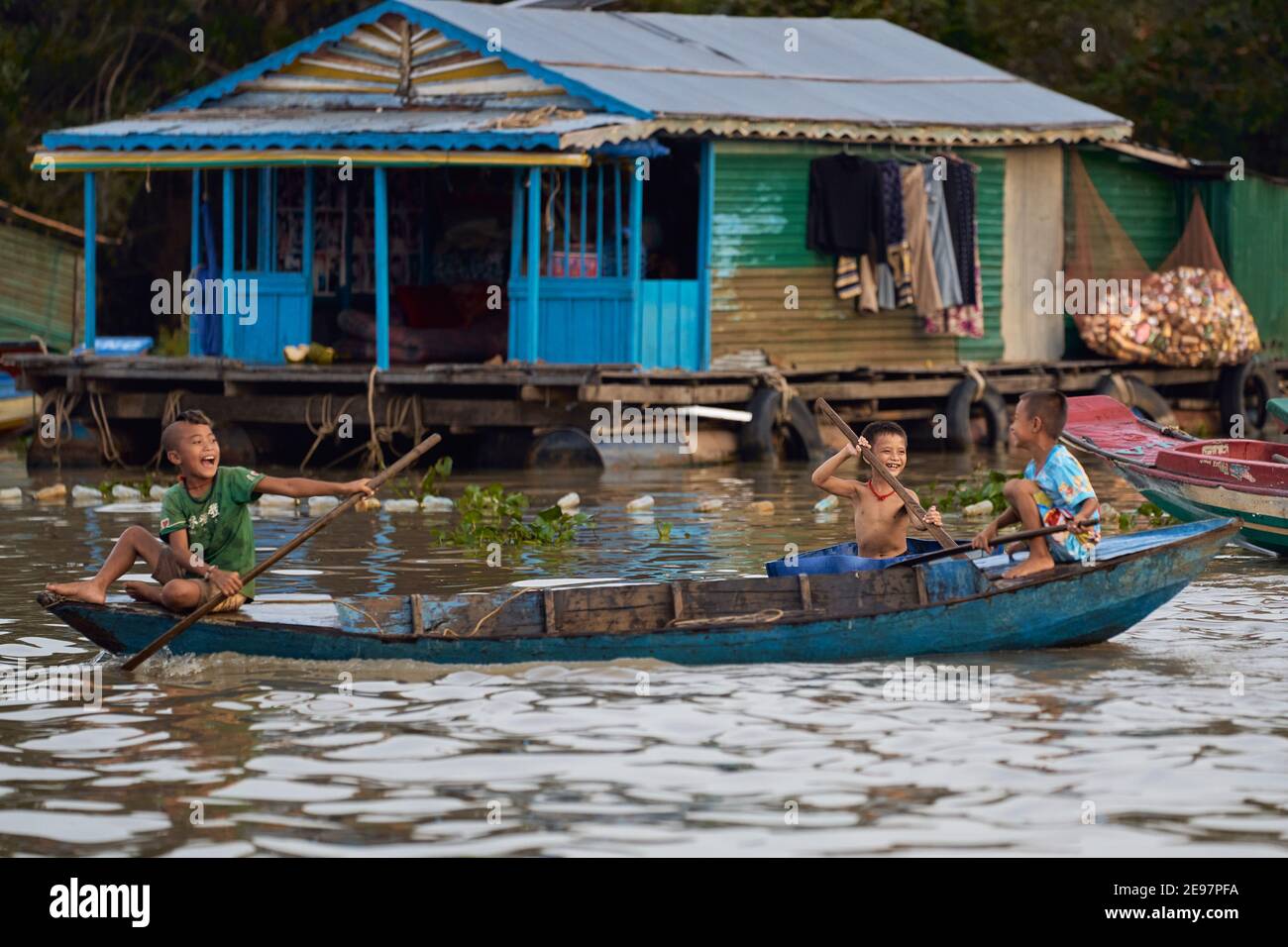 Exploring the floating village of Tonlé Sap lake where children entertain themselves on boats Stock Photo