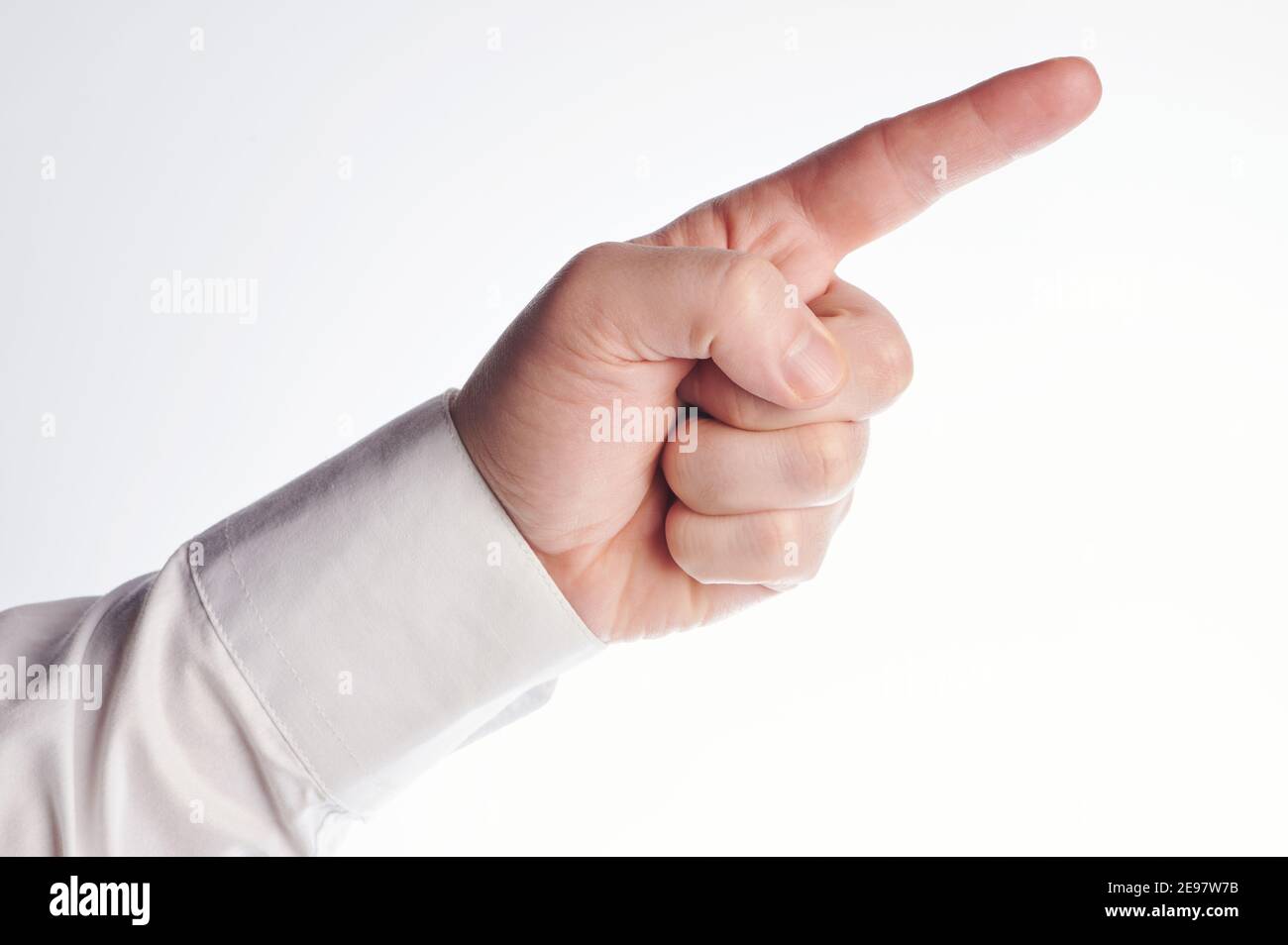 One point finger in hand with white shirt isolated on studio background ...