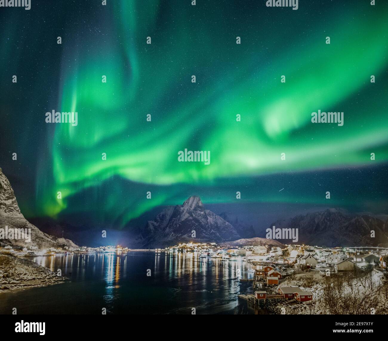 Northern Lights on the starry sky seen over Reine village on Lofoten ...