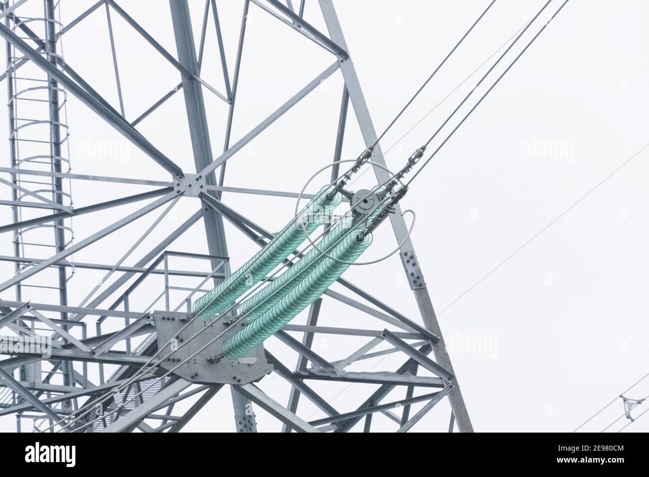 Glass insulators on highvoltage power line poles Stock Photo Alamy