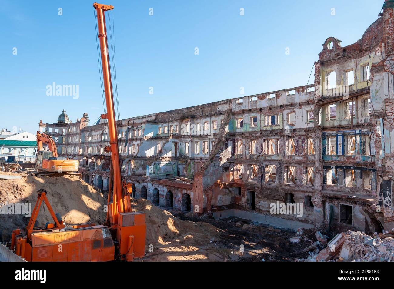 Reconstruction and restoration of the old building. The walls are reinforced with scaffolding and supports Stock Photo