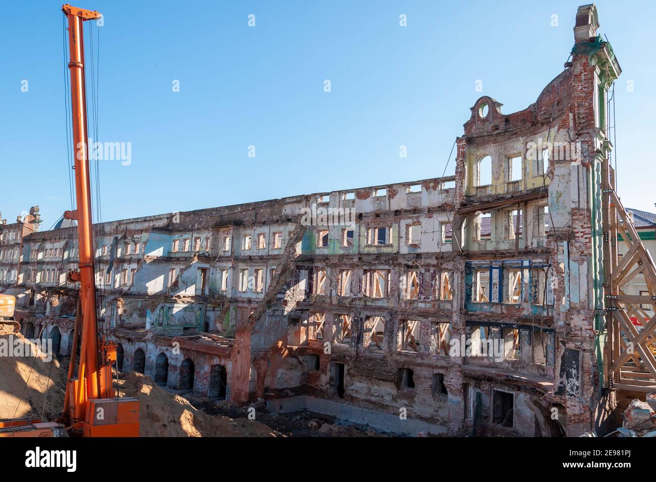 Reconstruction and restoration of the old building. The walls are reinforced with scaffolding and supports Stock Photo