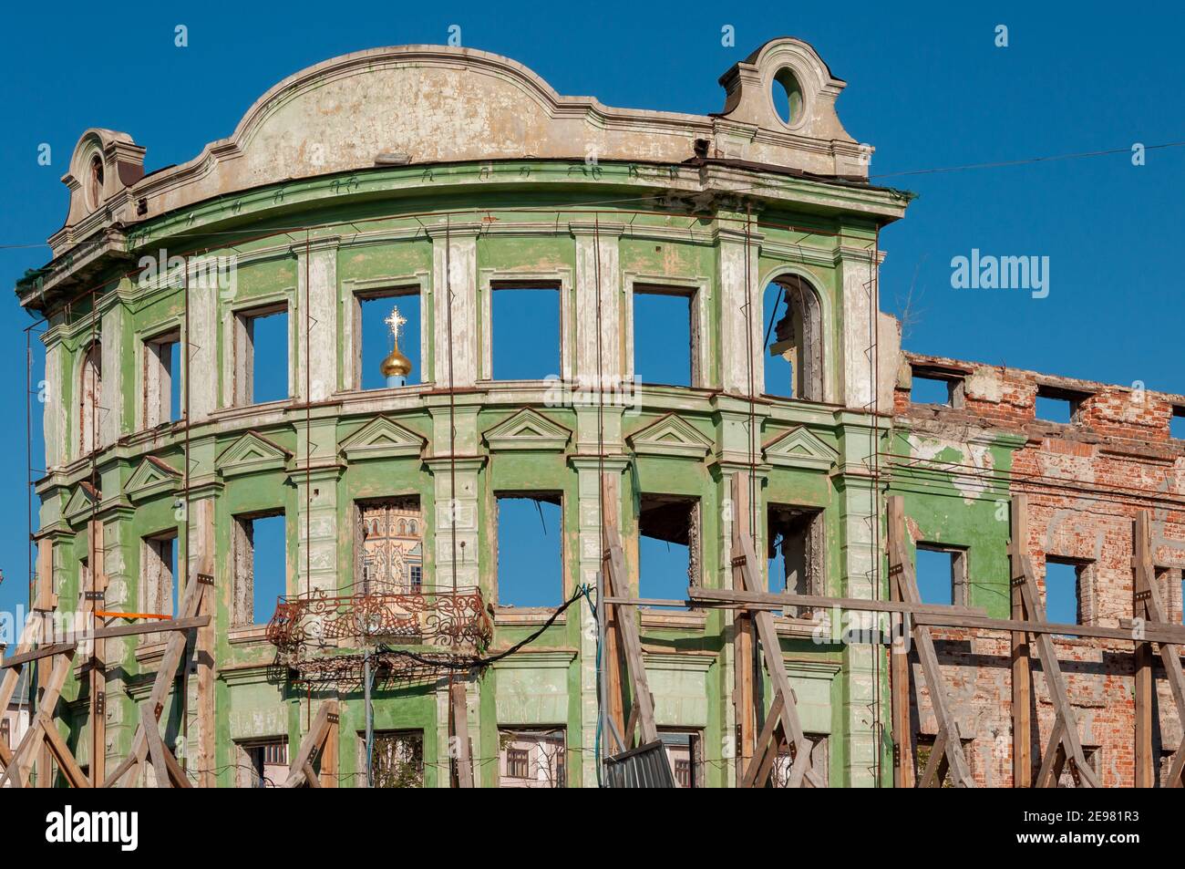 Reconstruction and restoration of the old building. The walls are reinforced with scaffolding and supports Stock Photo