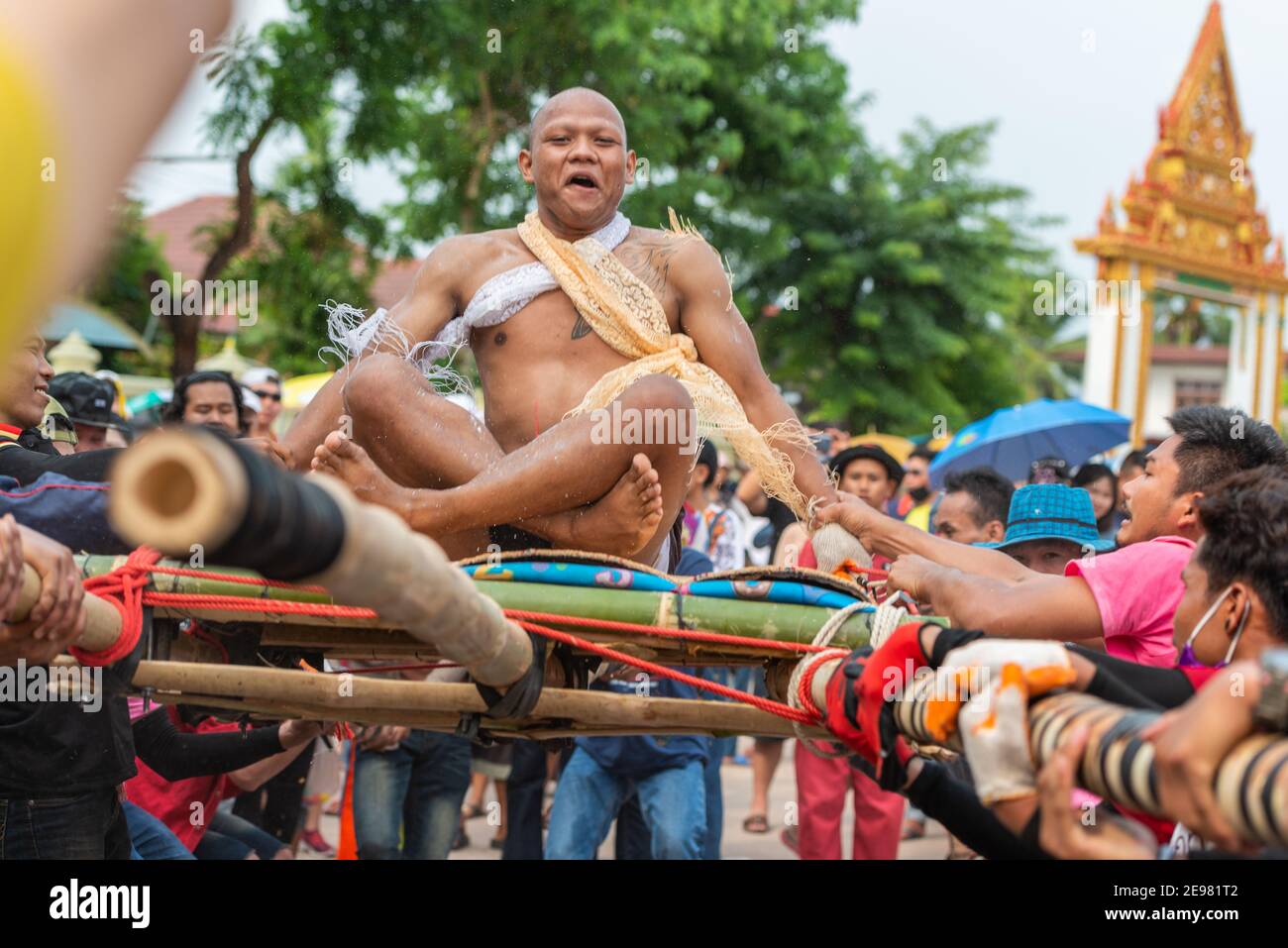 Chaiyaphum, Thailand - May 12, 2019: Parade of ancient pre-ordination of Buddhist which pre-monk on bamboo litter shaken severely before ordination in Stock Photo