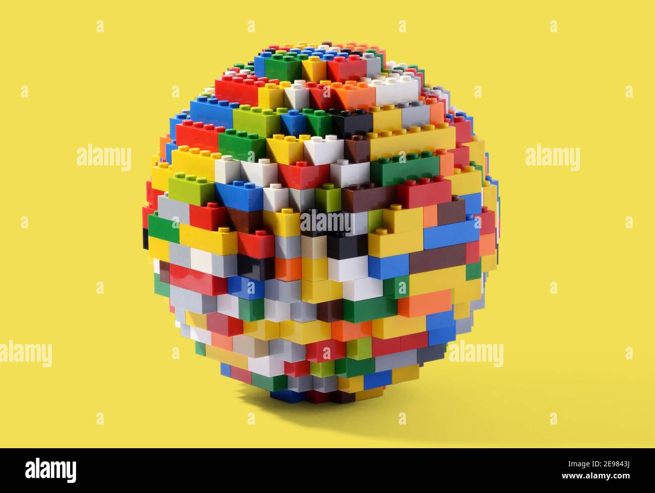 Circular globe or sphere constructed of multicolored interlocking Lego blocks, a well known childhood toy which can be assembled and disassembled mult Stock Photo
