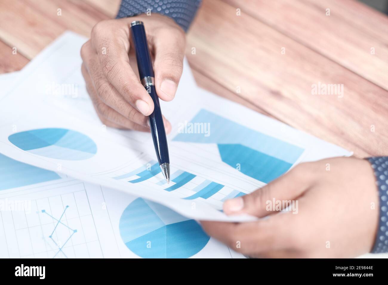 man hand with pen analyzing bar chart on paper Stock Photo - Alamy
