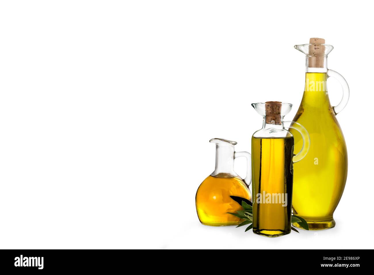 Extra virgin olive oil, three varieties of olive oil in bottles and glass jars isolated on white background. Stock Photo