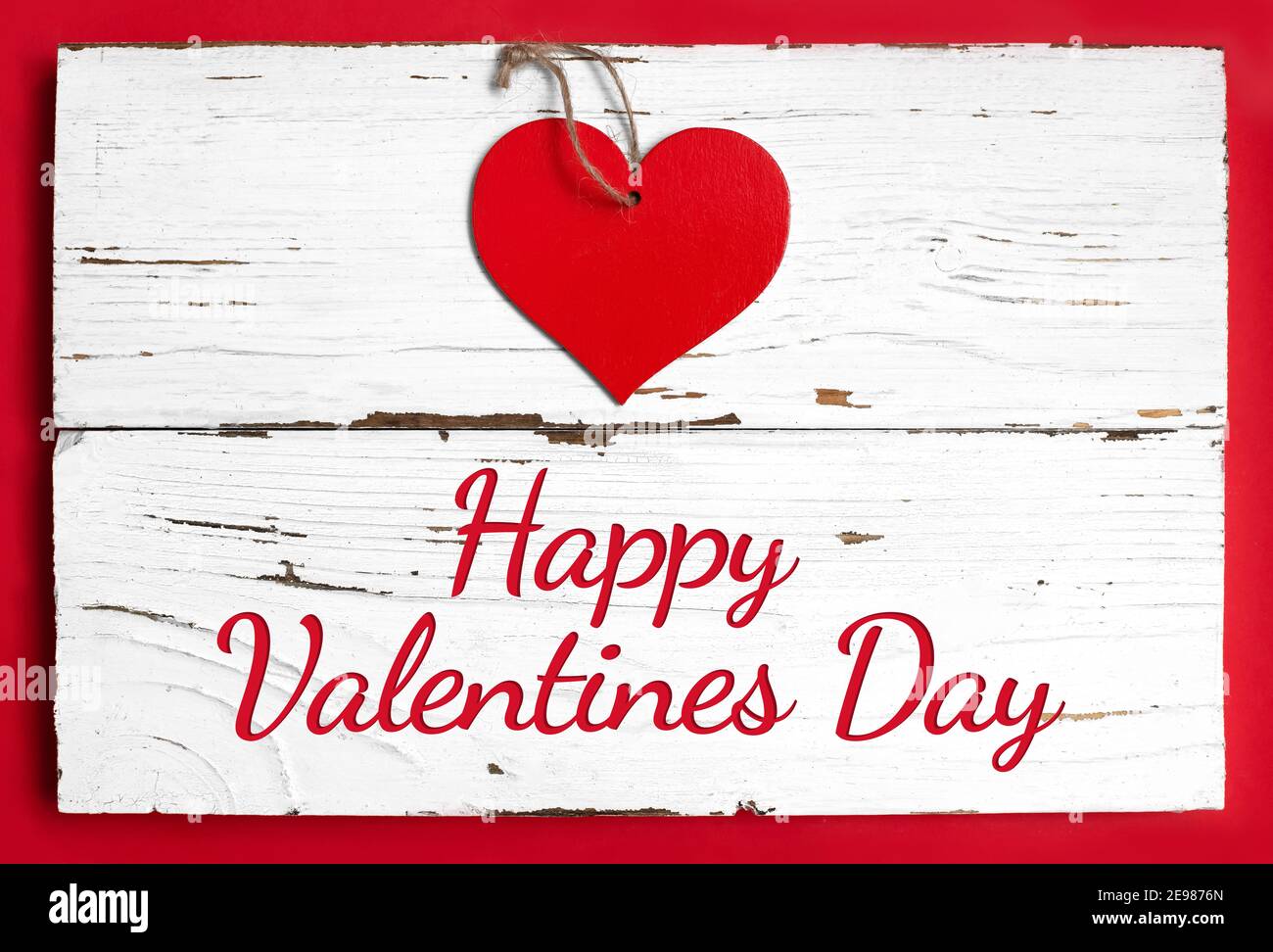 red heart on white wooden and red background with text Happy valentines ...