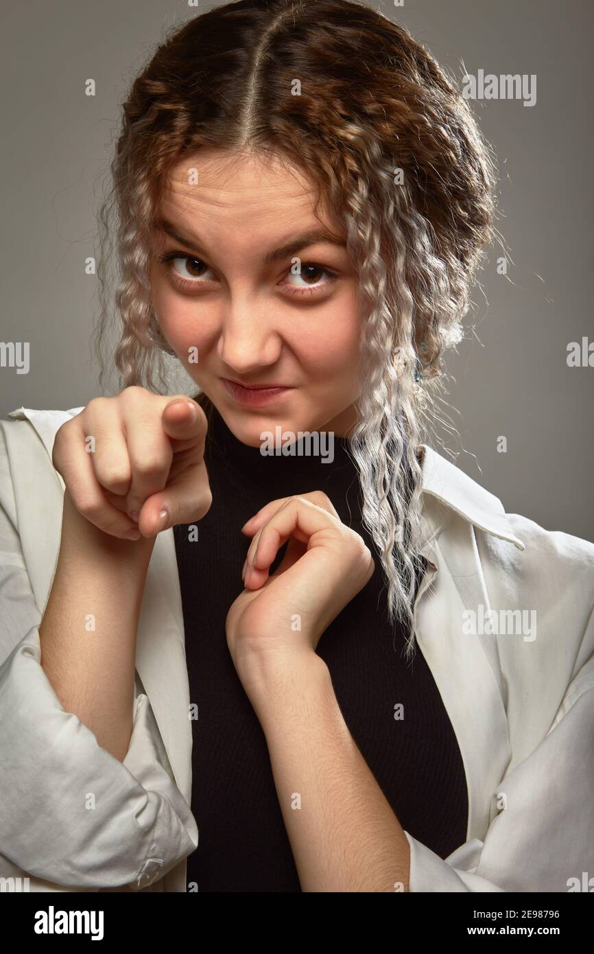 Shy Fun shy fun girl point at camera, making grimace Stock Photo - Alamy