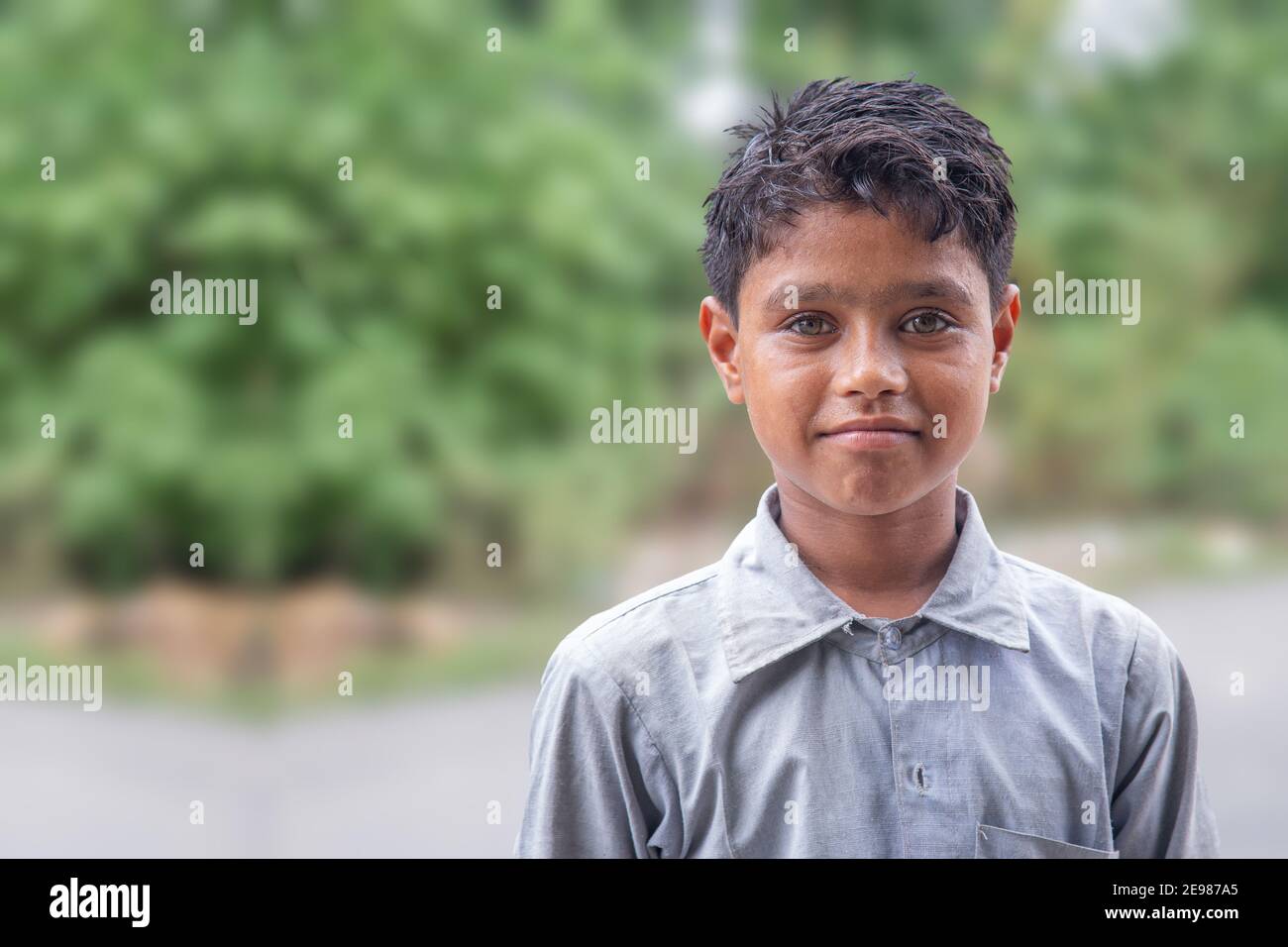 Portrait of Indian Village boy standing in blur background Stock Photo