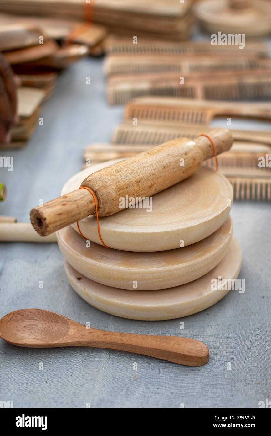 Picture of handmade wooden roti maker is displayed in a shop for sale in blurred background. Indian handicraft.(Selective Focus) Stock Photo