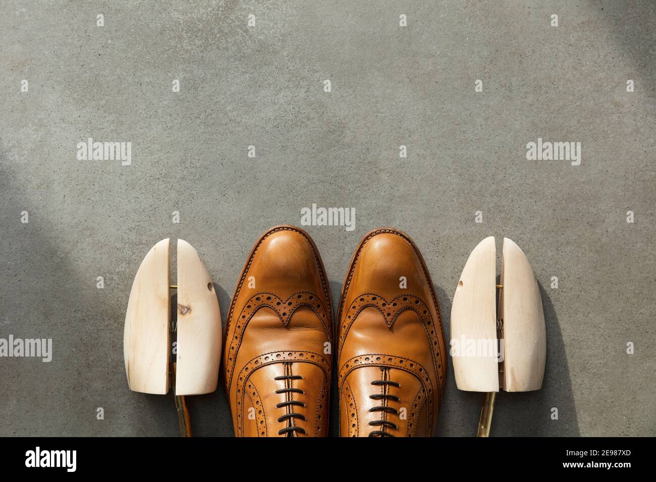 Overhead view of a pair of tan brown leather mens formal shoes on
