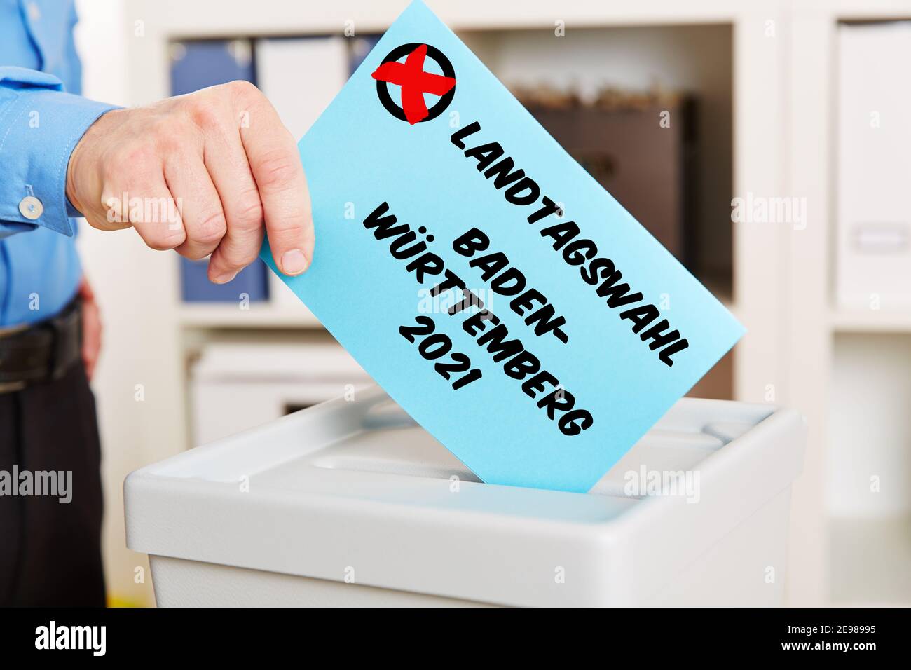Hand when voting for the Landtagswahl (German for: state election) 2021 in Baden-Württemberg puts voting paper in a ballot box Stock Photo