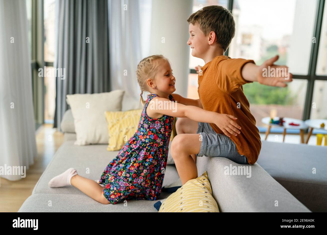 Happy little brother and sister having fun and love together. Family, sibling, love concept Stock Photo