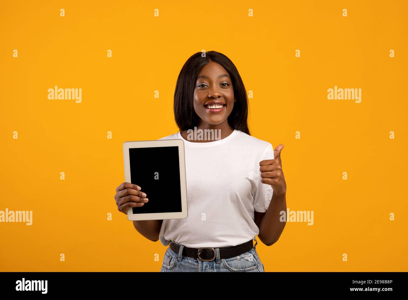 Pretty black woman showing digital tablet with empty screen Stock Photo ...