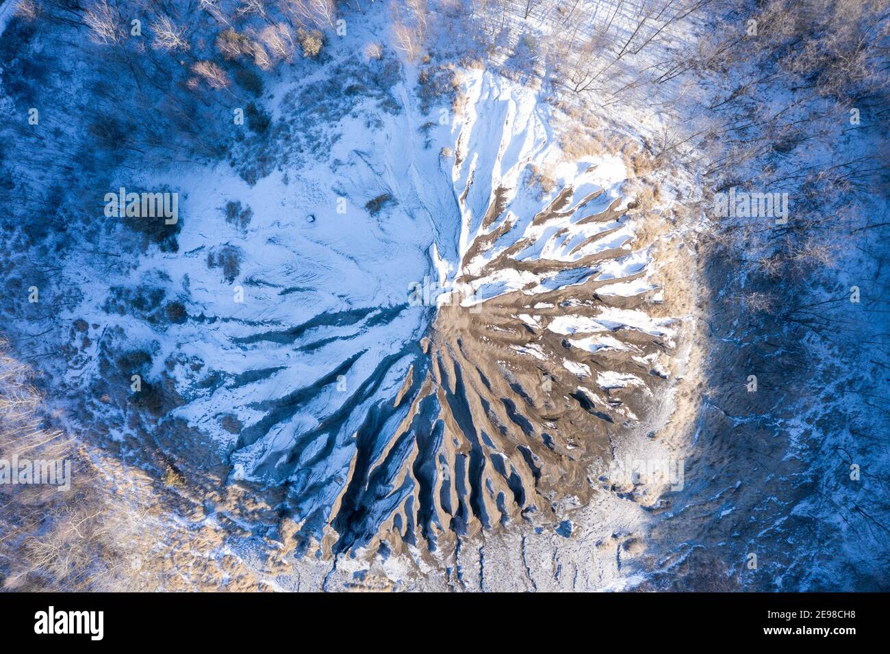 Amazing aerial  view of abandoned slag heap covered by snow and grass, winter landscape. Hungarian name is zagyvarónai salakkúp. Stock Photo