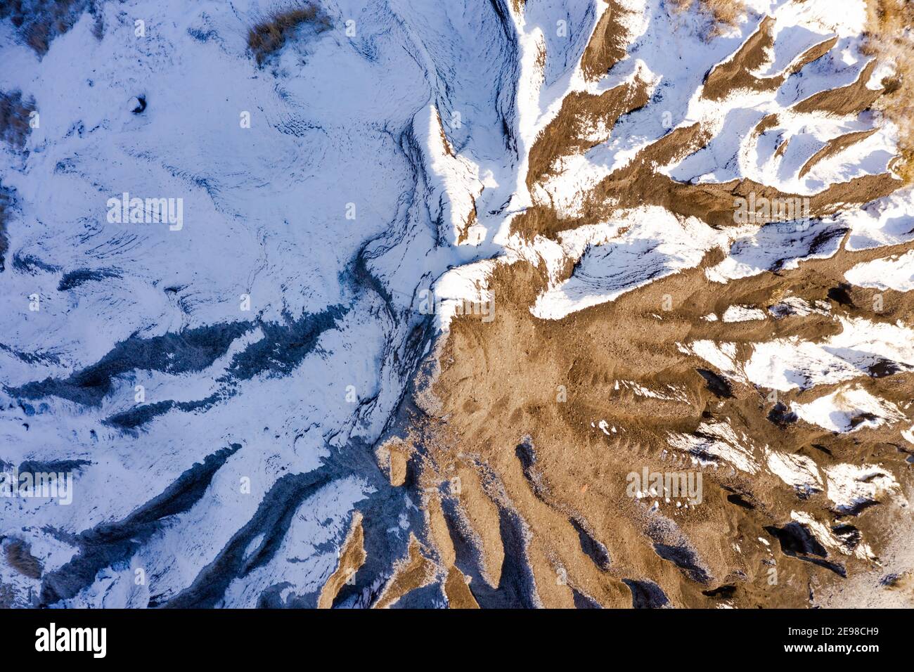 Amazing aerial  view of abandoned slag heap covered by snow and grass, winter landscape. Hungarian name is zagyvarónai salakkúp. Stock Photo