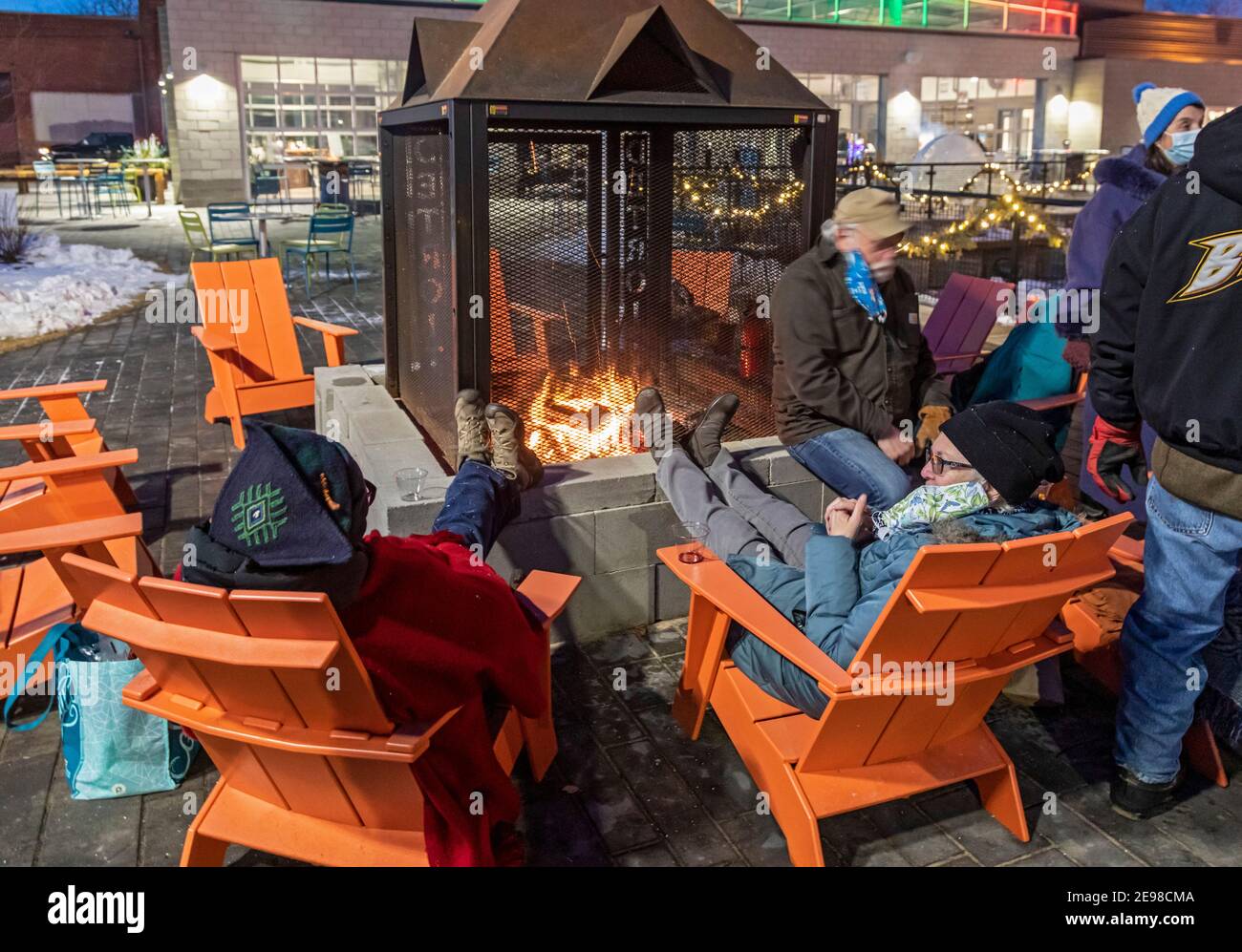Detroit, Michigan - People sit around a fire at Robert C. Valade Park on the east riverfront. The park, part of the Detroit Riverfront Conservancy, pr Stock Photo