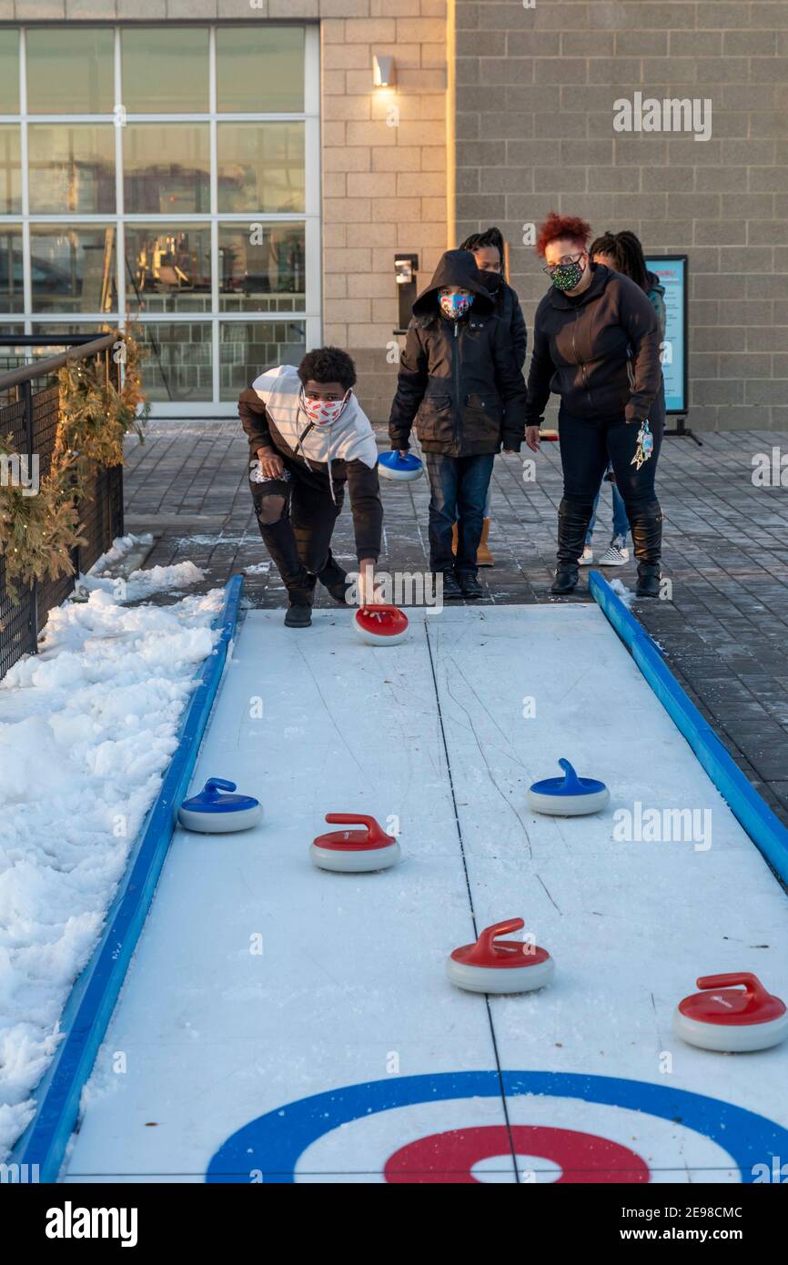 Detroit, Michigan - Synthetic ice curling at Robert C. Valade Park on the east riverfront. The park, part of the Detroit Riverfront Conservancy, progr Stock Photo