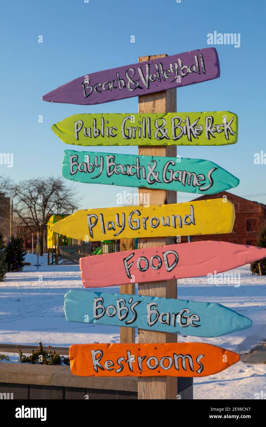 Detroit, Michigan - Direction signs at Robert C. Valade Park on the east riverfront. The park, part of the Detroit Riverfront Conservancy, programs a Stock Photo