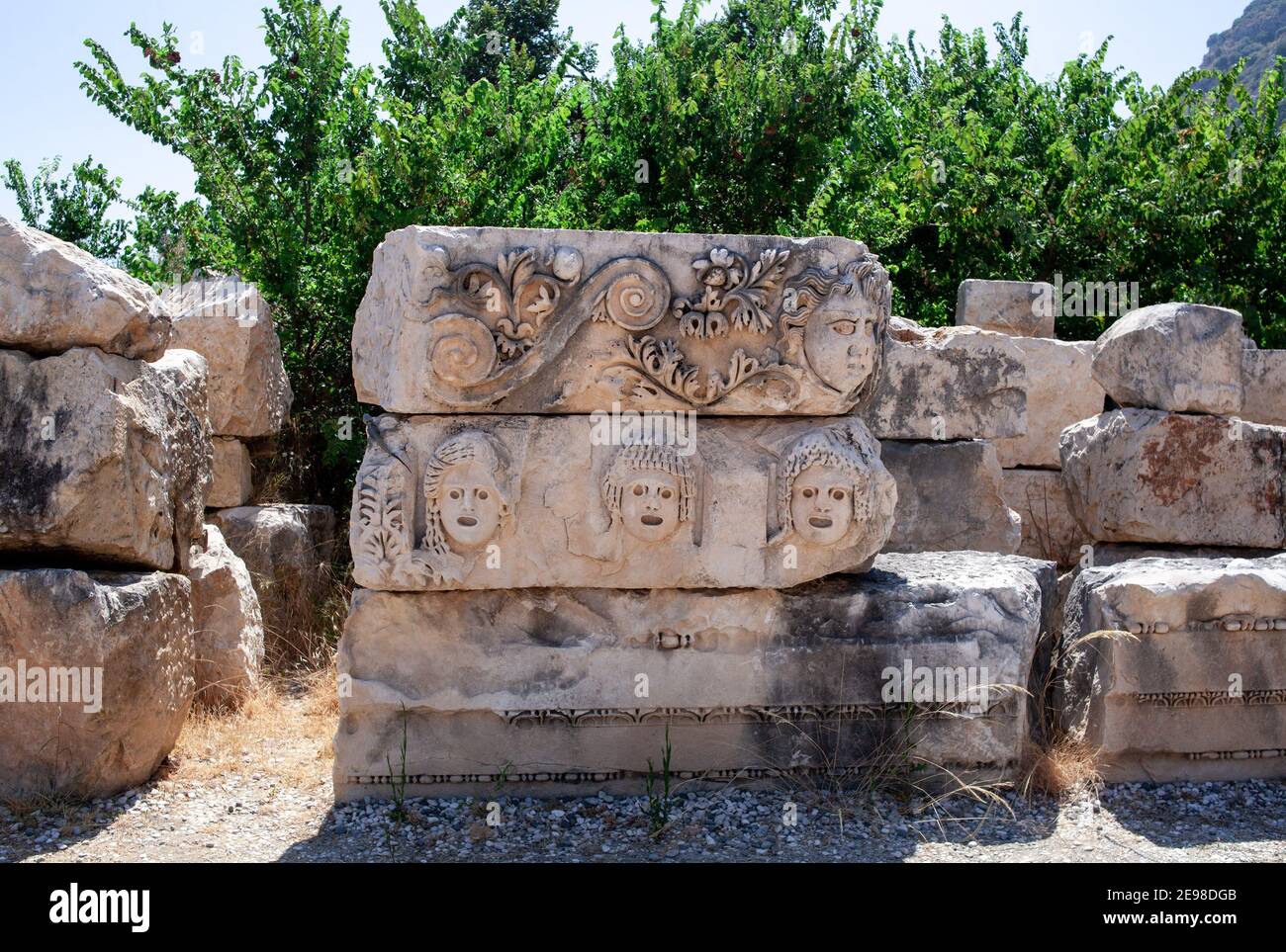 Bas reliefs on the ancient stone. Faces are carved in stone. Myra ...