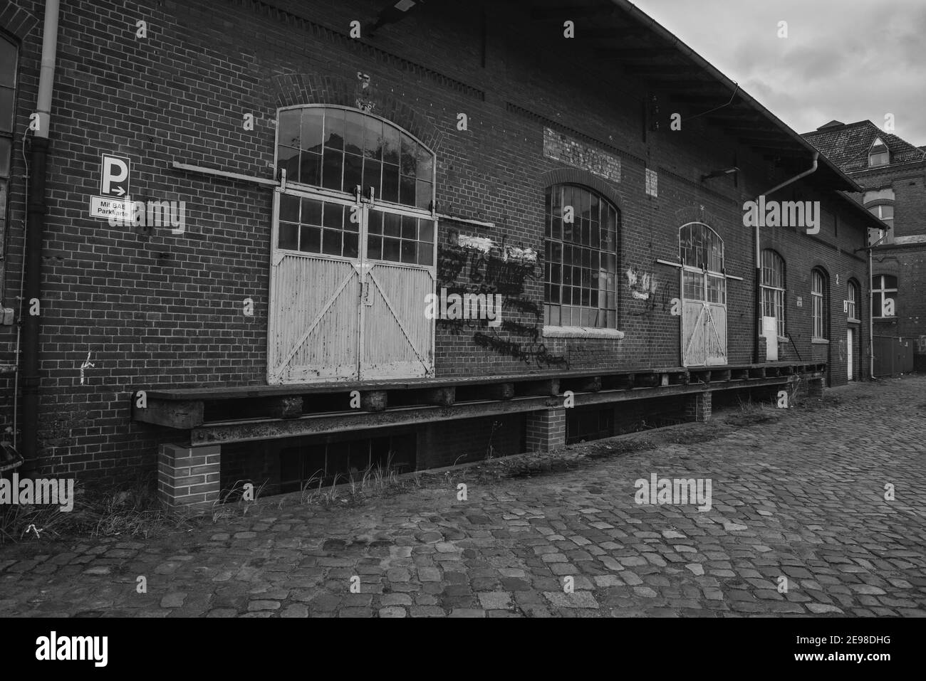 The loading ramp of an old warehouse, loading ramp and a sliding gate of an old warehouse, black and white photo Stock Photo