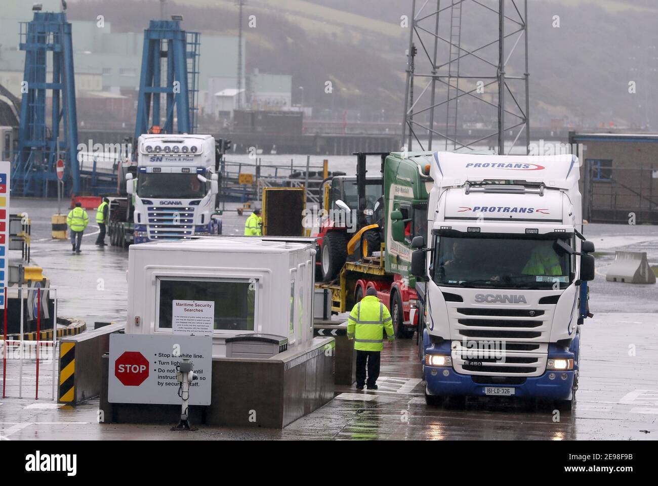 Trucks leaving Larne Port. The DUP has rejected claims it is whipping up tensions over Irish Sea trade in an effort to get Brexit's contentious Northern Ireland Protocol ditched. Physical inspections on goods entering Northern Ireland from Great Britain, which are required under the protocol, have been suspended amid threats and intimidation of staff. Picture date: Wednesday February 3, 2021. Stock Photo