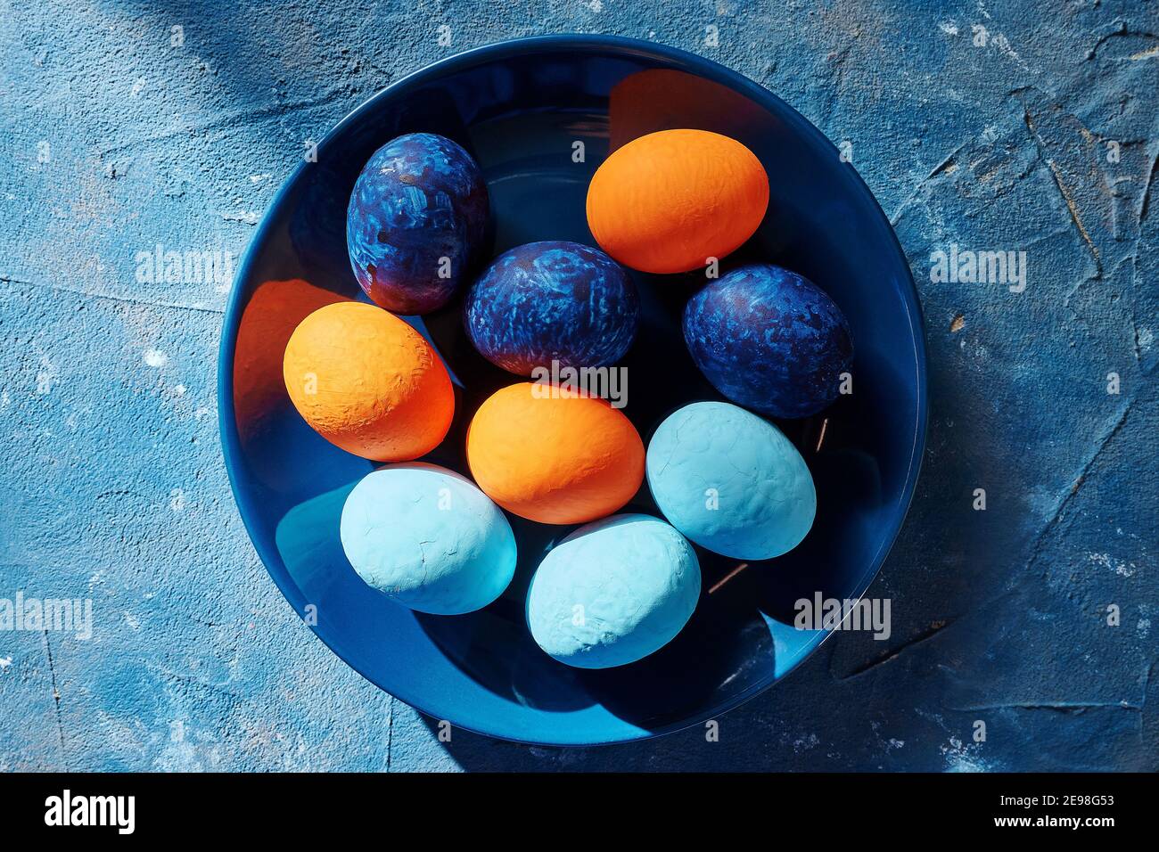 multi-colored chicken eggs in a blue plate. concept easter Stock Photo