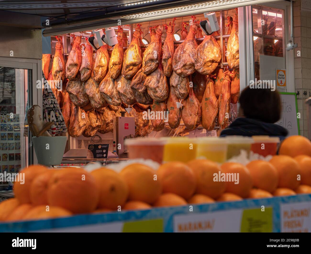 Dry cured serrano ham joints displayed in a market in Valencia Spain