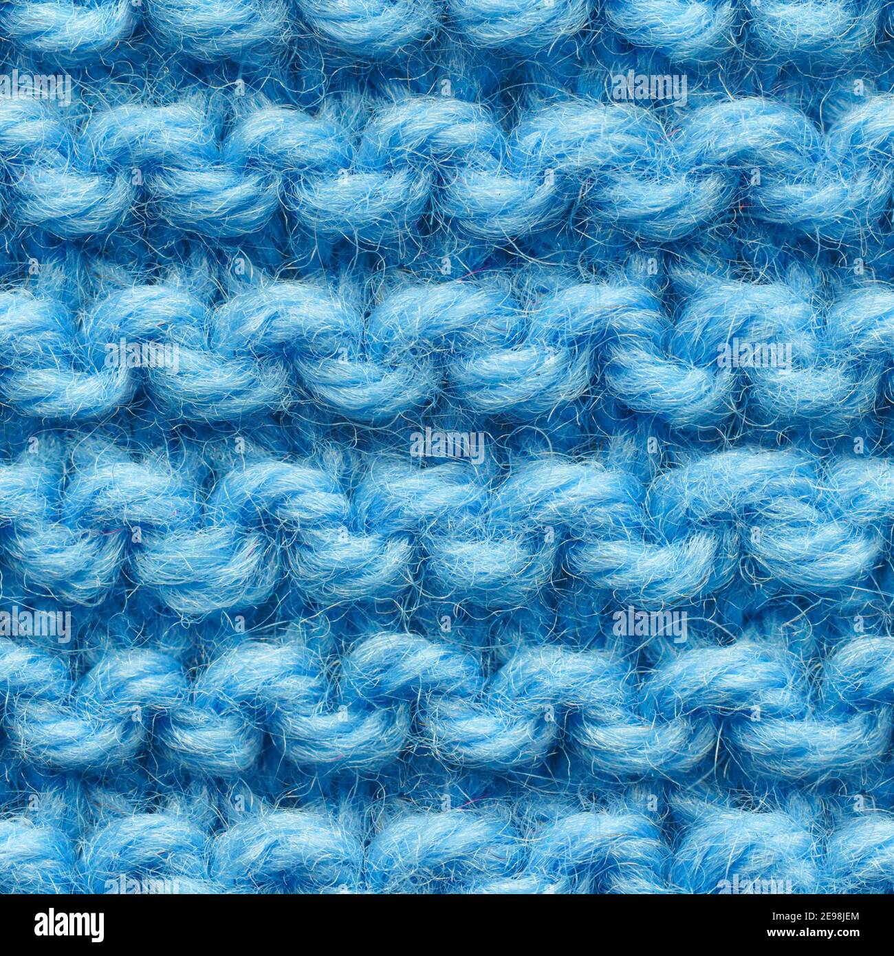 Blue knitted fabric seamless pattern for borderless fill. Knitted fabric repeating pattern for background close up. Stock Photo