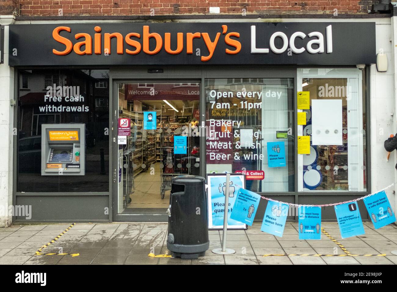 London- Sainsburys local store in Acton, west London with Covid 19 signage and queuing area Stock Photo