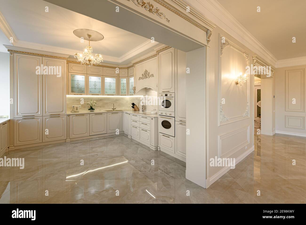 Luxury beige and gold classic kitchen and living room interior in studio flat Stock Photo