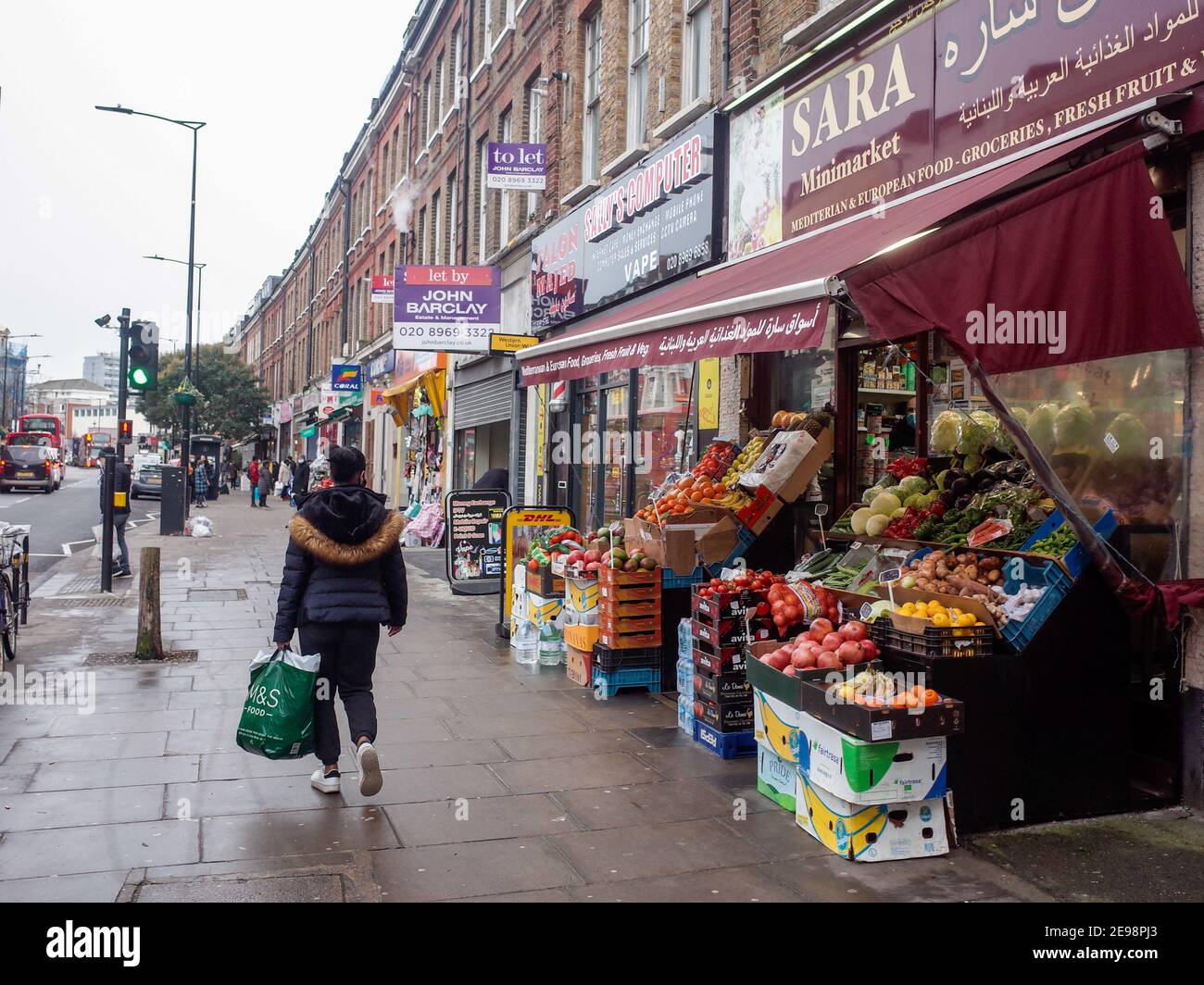 London- Harrow Road, a long street of high street shops in west London Stock Photo