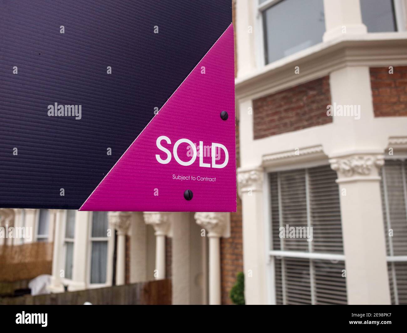 Property 'Sold' sign on urban UK street Stock Photo