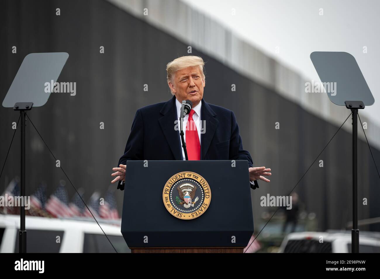 PRESIDENT DONALD TRUMP VISITS THE BORDER WALL WITH MEXICO DURING THE LAST DAYS OF HIS PRESIDENCY. The Mexico–United States barrier, also known as the border wall, is a series of vertical barriers along the Mexico–United States border intended to reduce illegal immigration to the United States from Mexico. The barrier is not a continuous structure but a series of obstructions variously classified as 'fences' or 'walls'.  Between the physical barriers, security is provided by a 'virtual fence' of sensors, cameras, and other surveillance equipment. Stock Photo