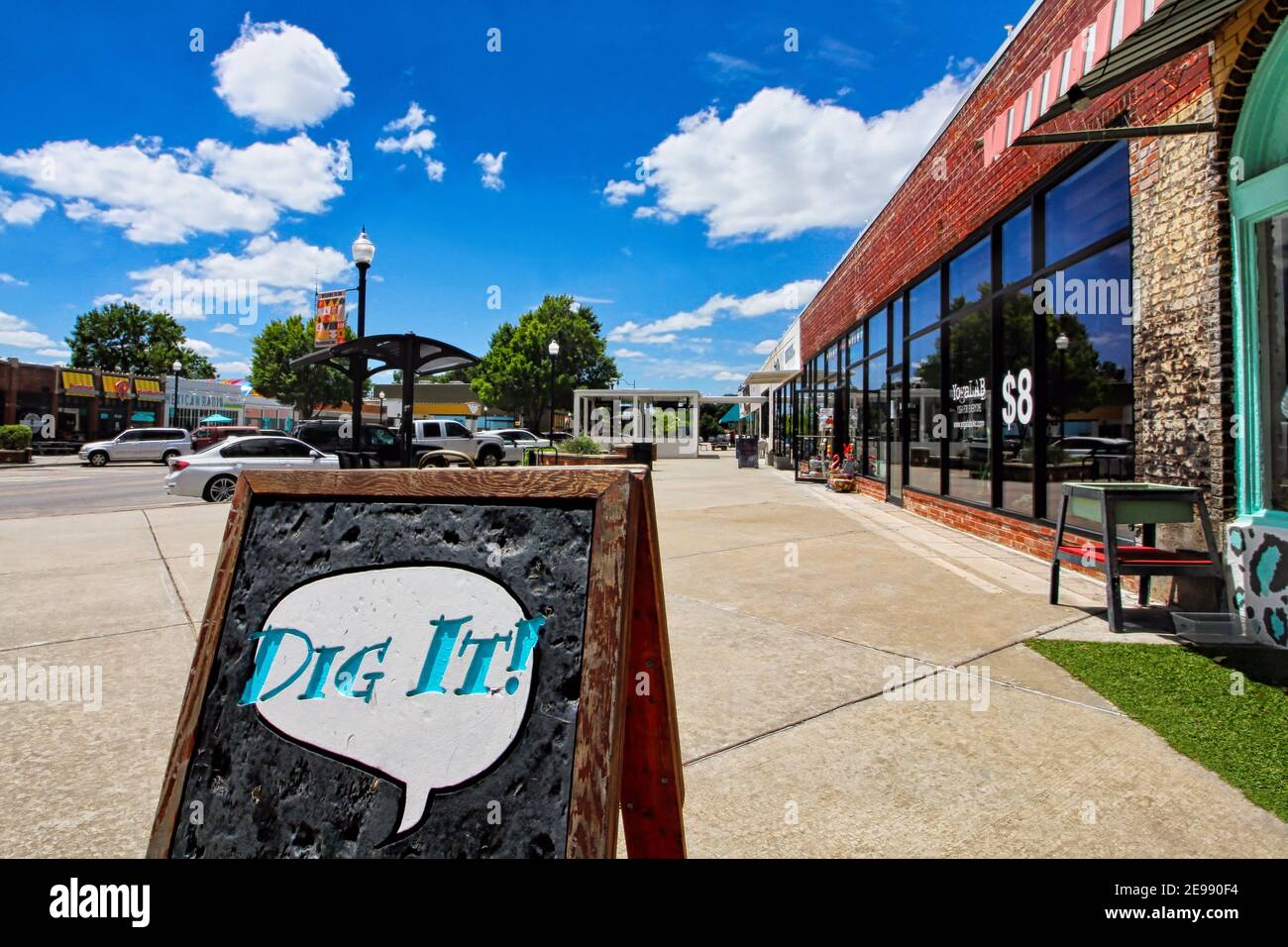 A wood sidewalk sign saying 'Dig It' sits in the 16th Street Plaza District in Oklahoma City. Stock Photo