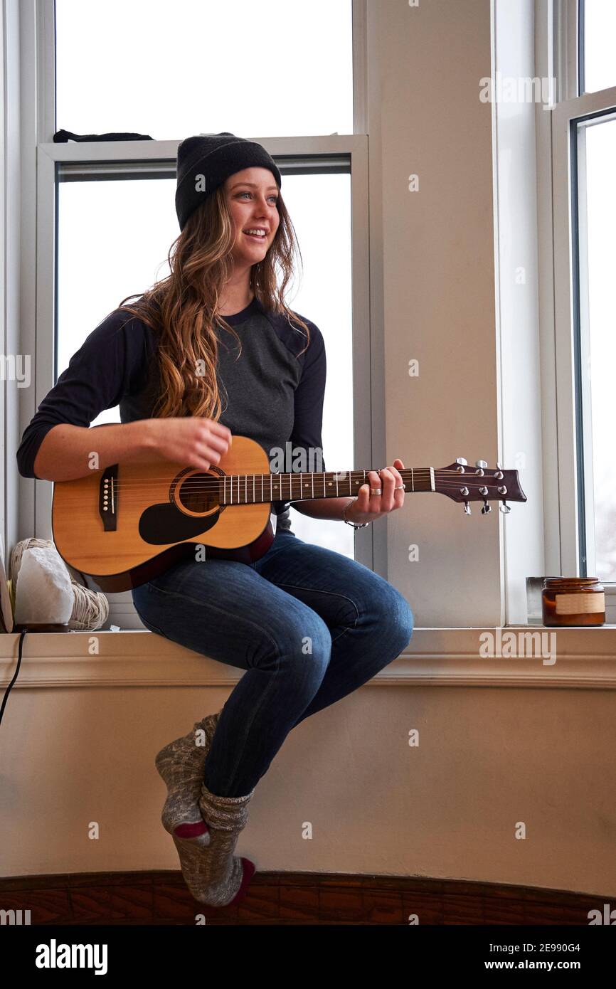Young female musician playing guitar in the morning, Montreal, Quebec,  Canada Stock Photo - Alamy