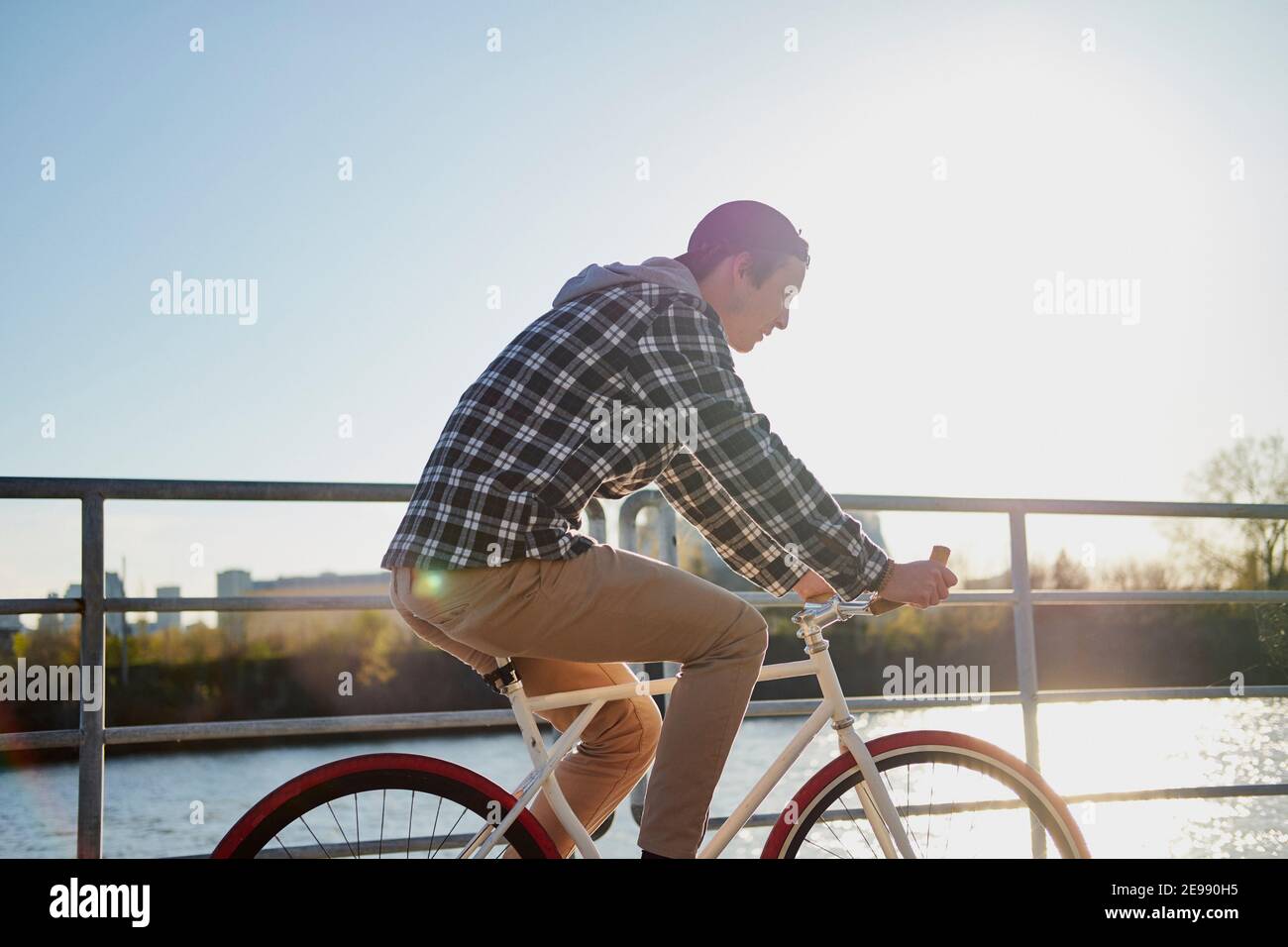 Youthful man on fixed gear bike cycling around city, Montreal, Quebec, Canada Stock Photo