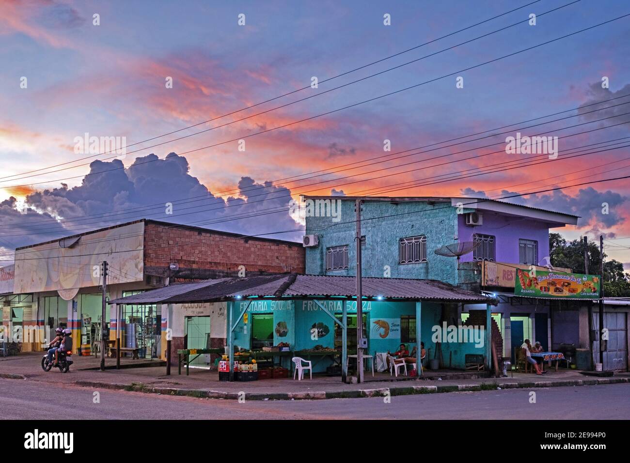 Shops, bars and restaurants in the village Rorainópolis at sunset along route 174, Roraima, Amazon region, Brazil Stock Photo