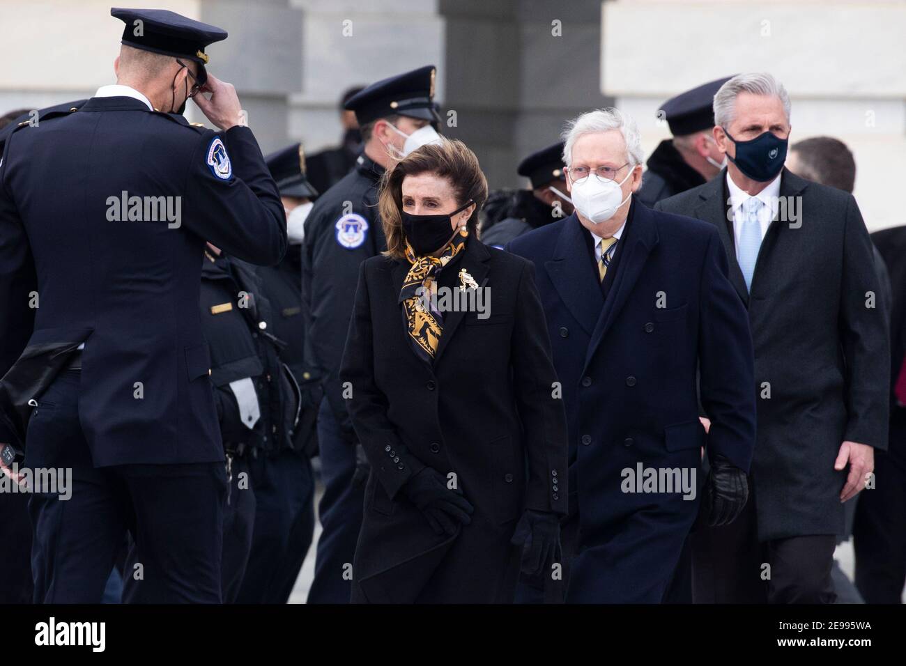 U.S. Speaker of the House Nancy Pelosi (L), Senate Minority Leader Mitch McConnell (C) and House Minority Leader Kevin McCarthy (R) walk out to watch the remains of Capitol Police Officer Brian Sicknick being carried down the East Front steps after 'lying in honor' in the Rotunda of the Capitol in Washington, DC, USA, 03 February 2021. Officer Sicknick was fatally injured while physically engaging with the mob at the US Capitol, on 06 January 2021.  (Photo by Pool/Sipa USA) Stock Photo