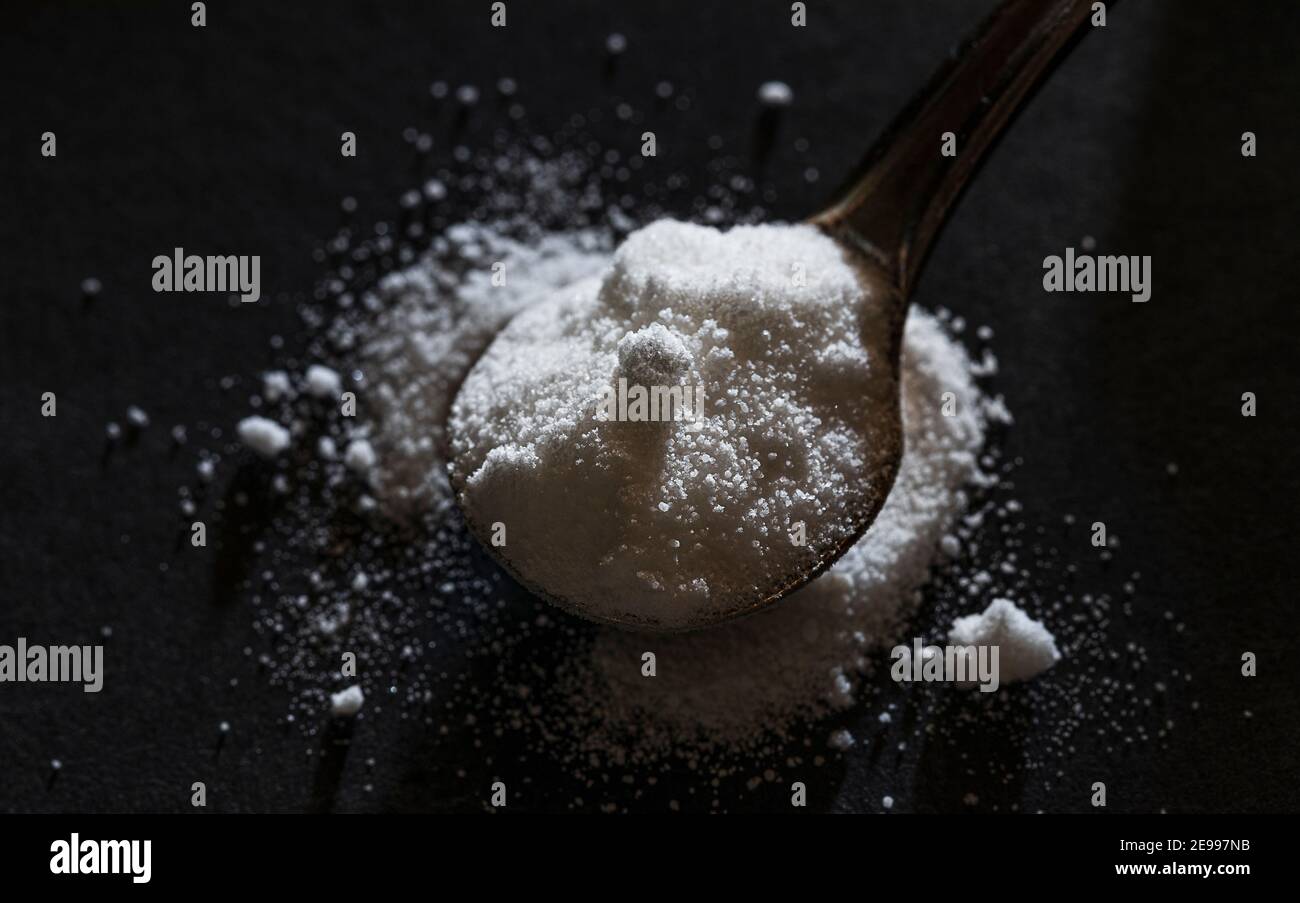 selective focus photo of citrulline malate in an iron spoon. dietary concept. dietary supplement low-key photo. Stock Photo